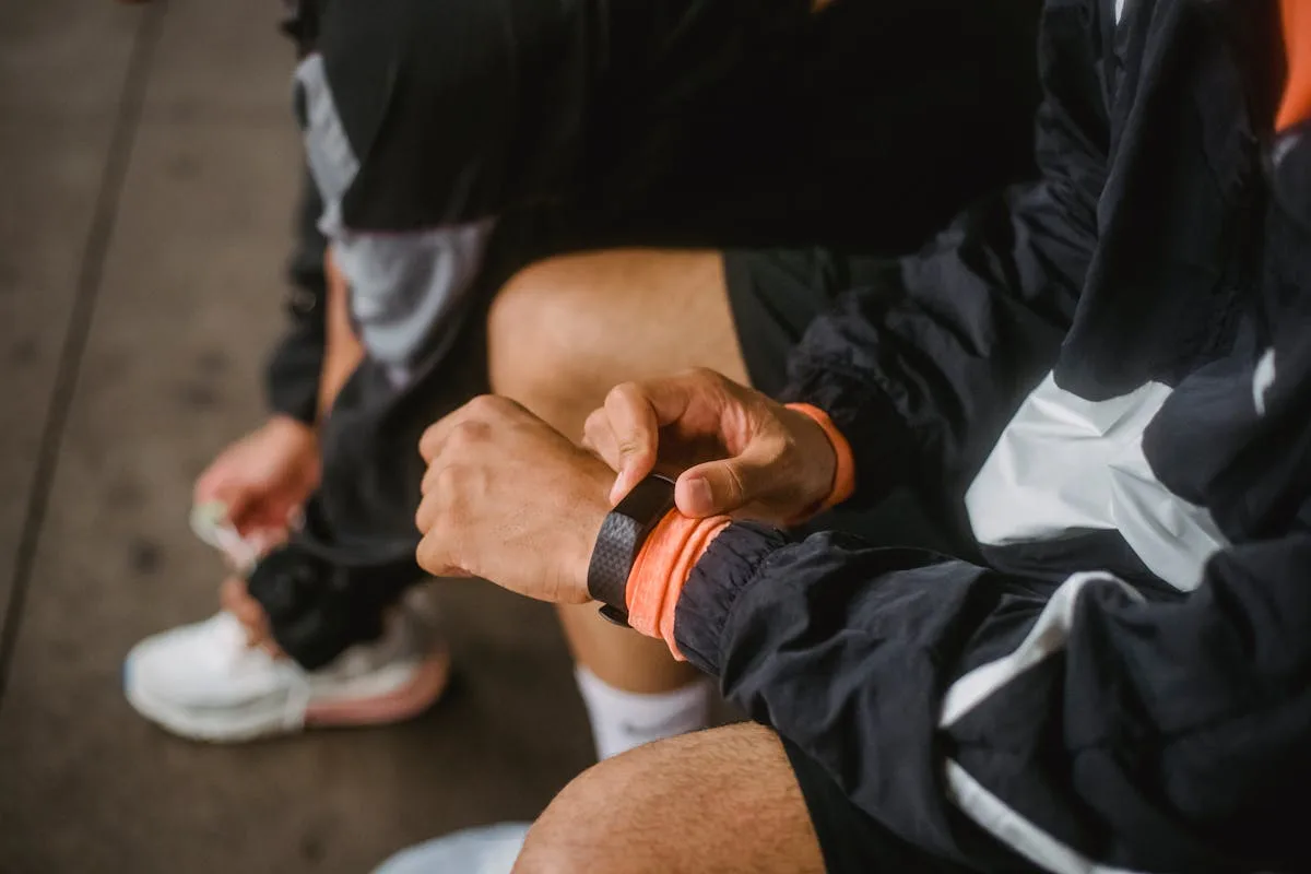 Athlete adjusting fitness tracker on wrist