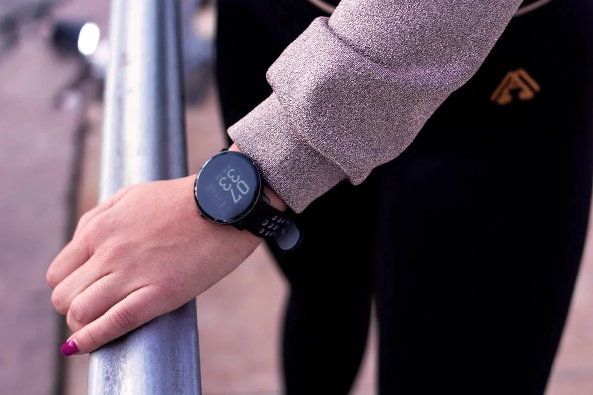 Woman checking smartwatch heart rate display