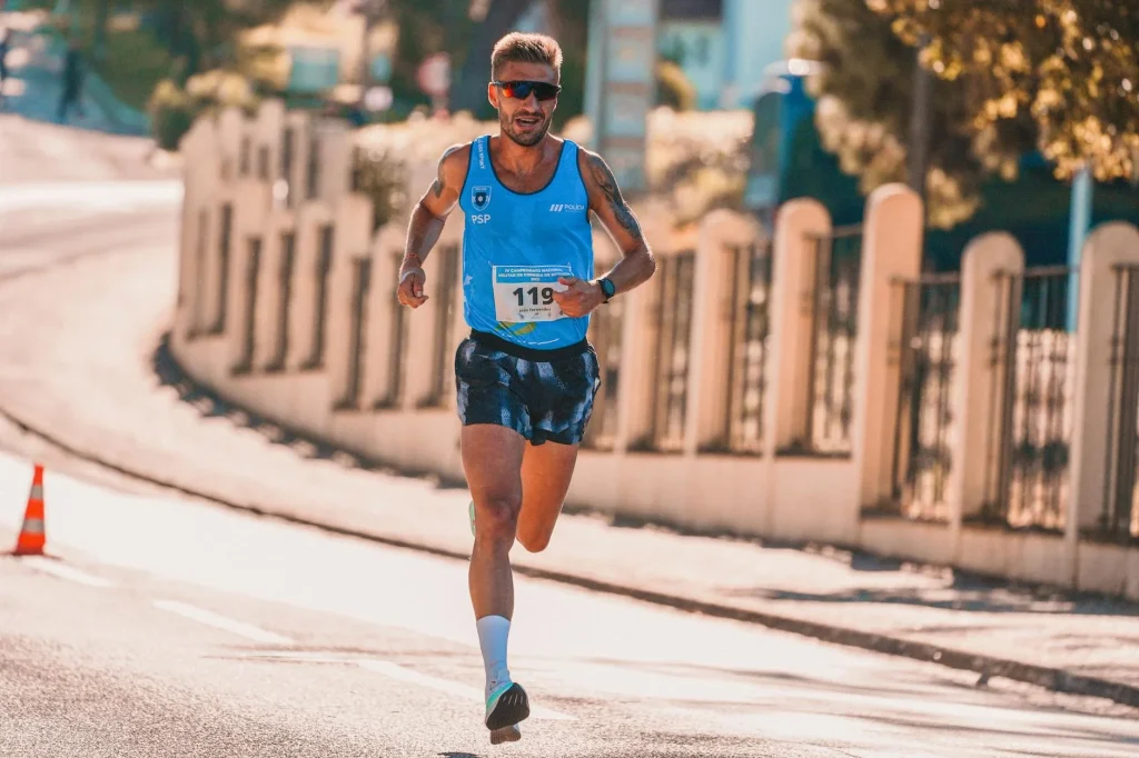 Runner holding energy gel packet during a road race