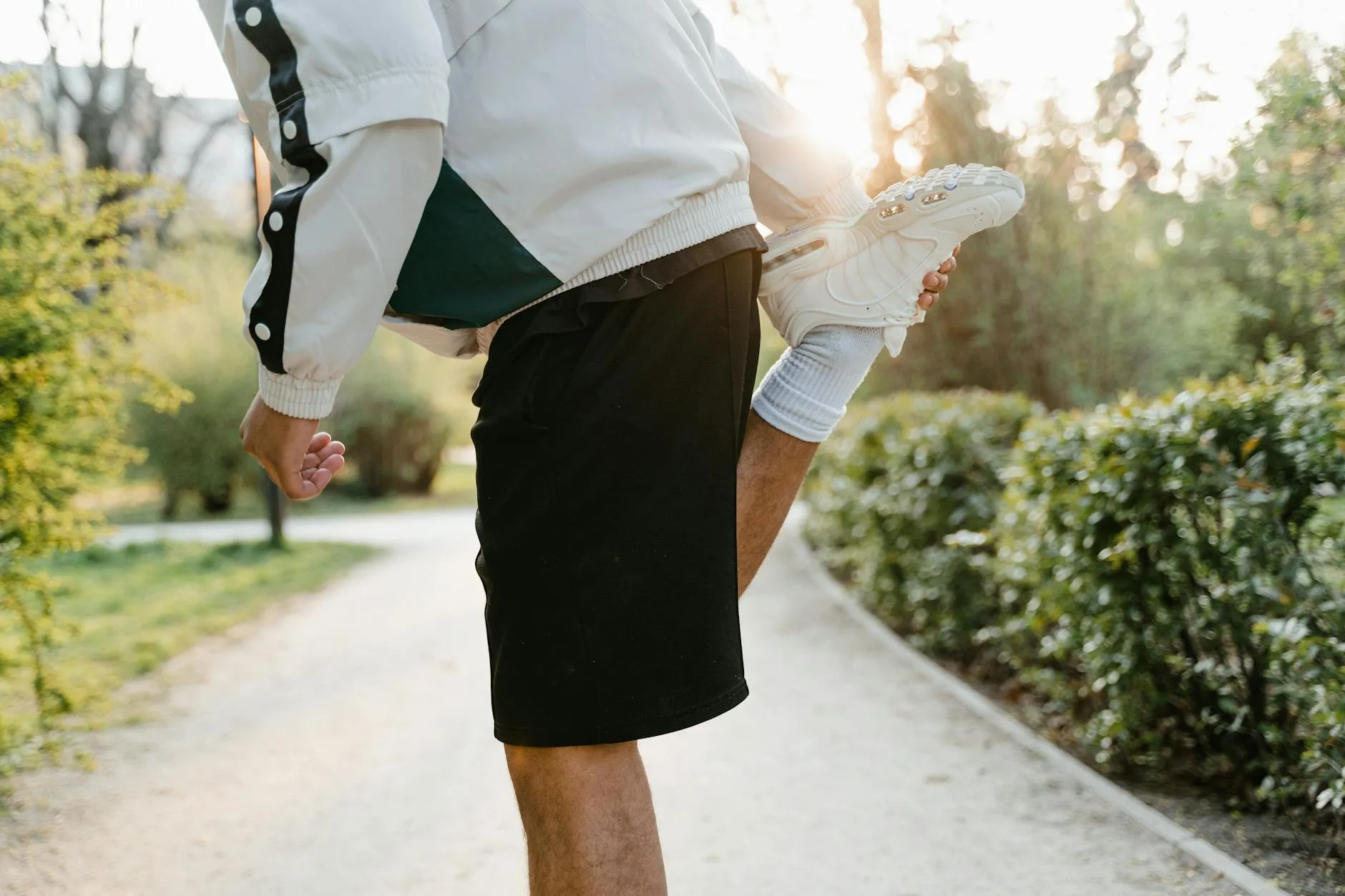 Runner doing a warm-up stretch before a cold weather run
