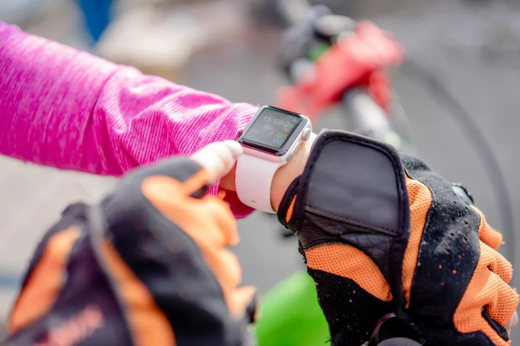 GPS running watch on wrist showing distance data
