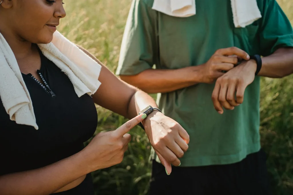Runner checking GPS watch on wrist during outdoor training session