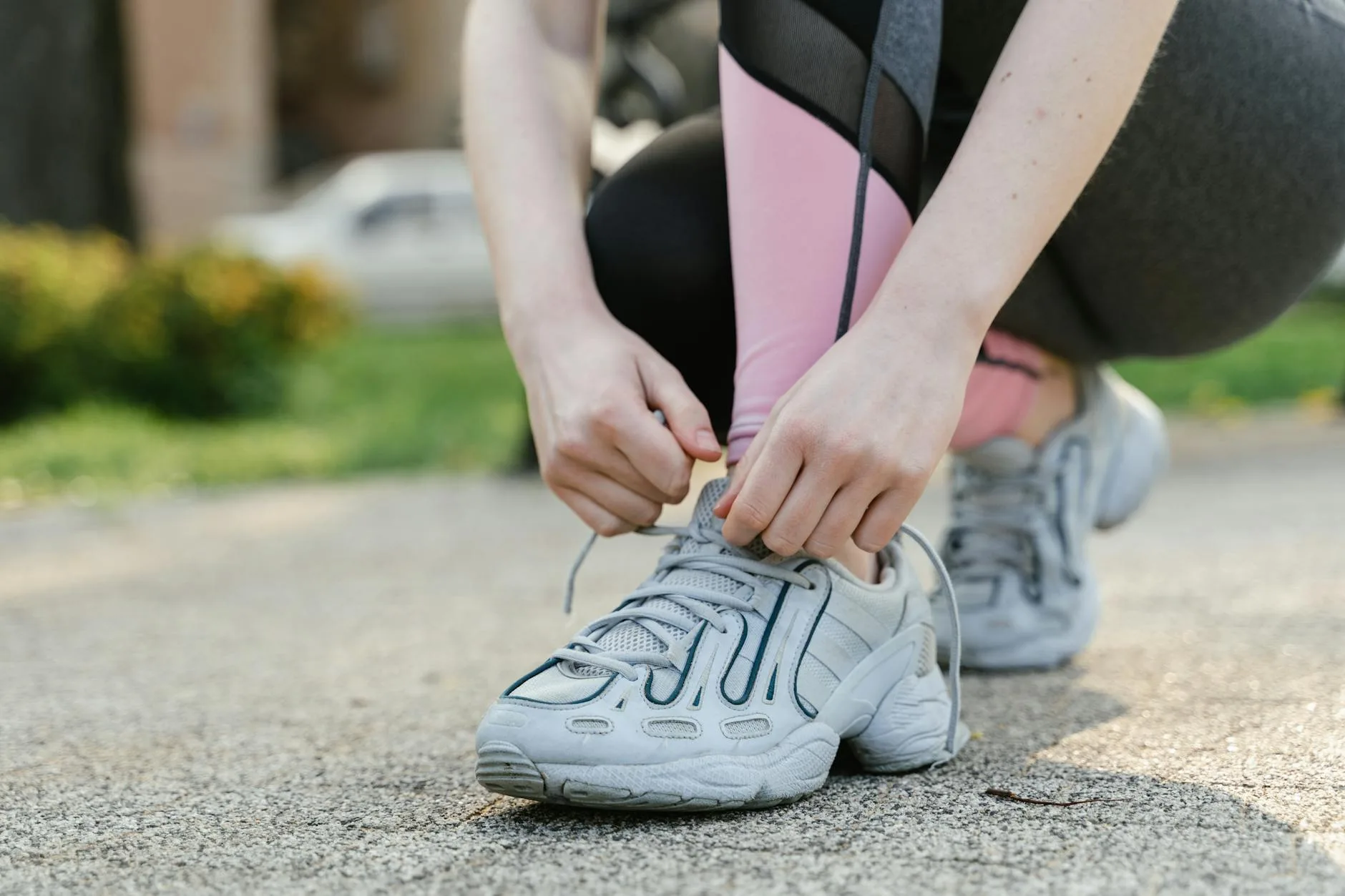 Person lacing up running shoes before a jog