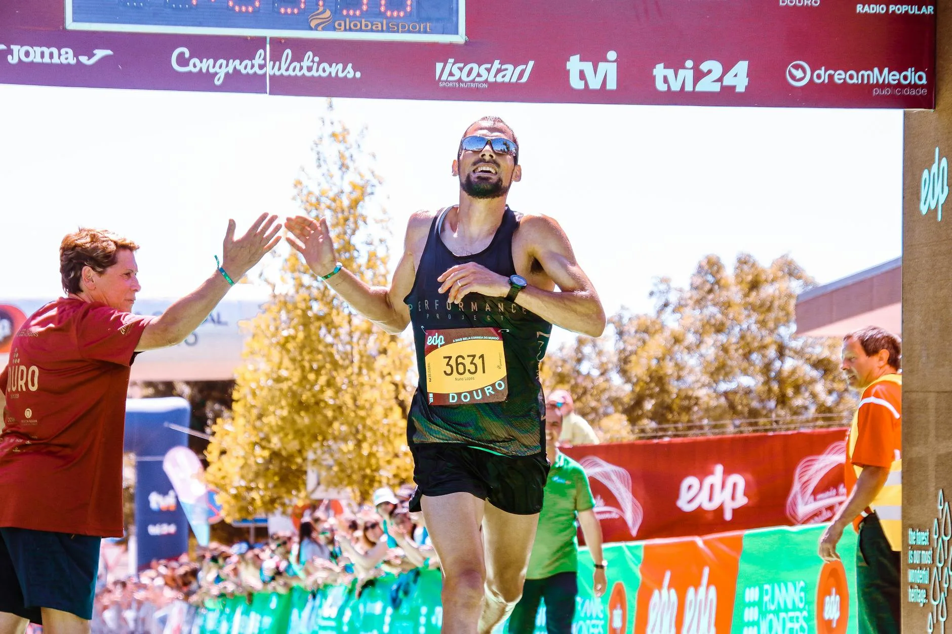 Runner crossing the marathon finish line in celebration