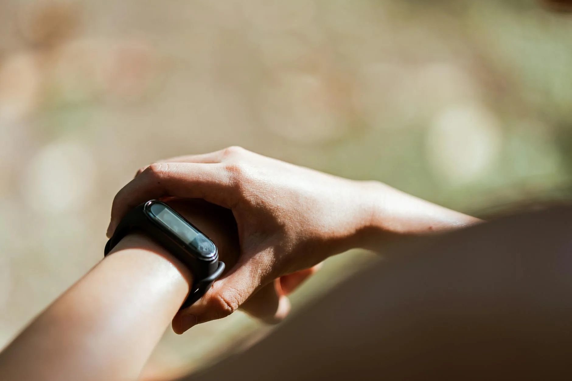 Runner checking a GPS smartwatch during outdoor training