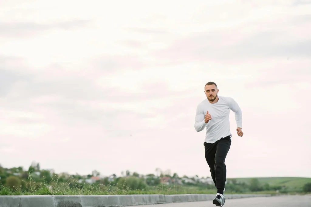 Runner checking GPS watch during a road run