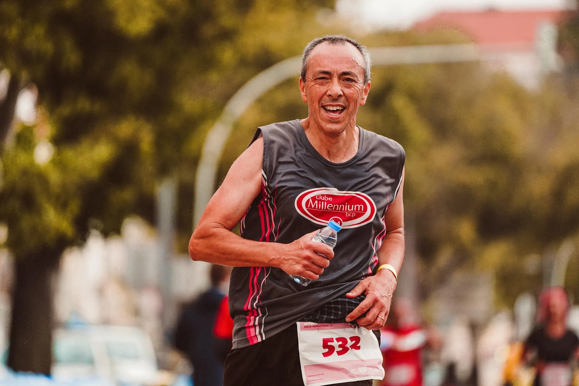 Runner drinking from a water bottle during a training run