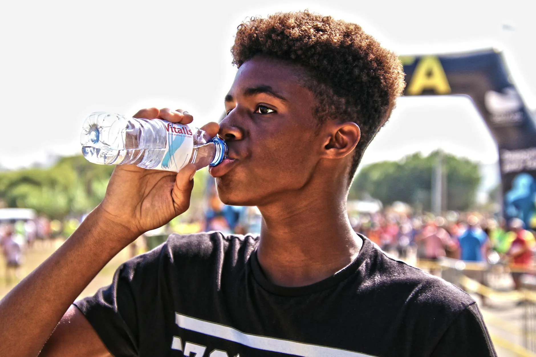 Runner drinking water for hydration during a race