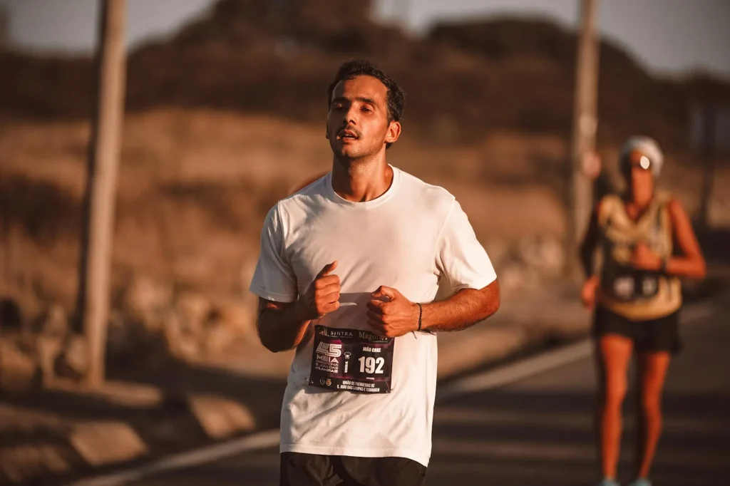 Runner jogging on a road in hot summer weather