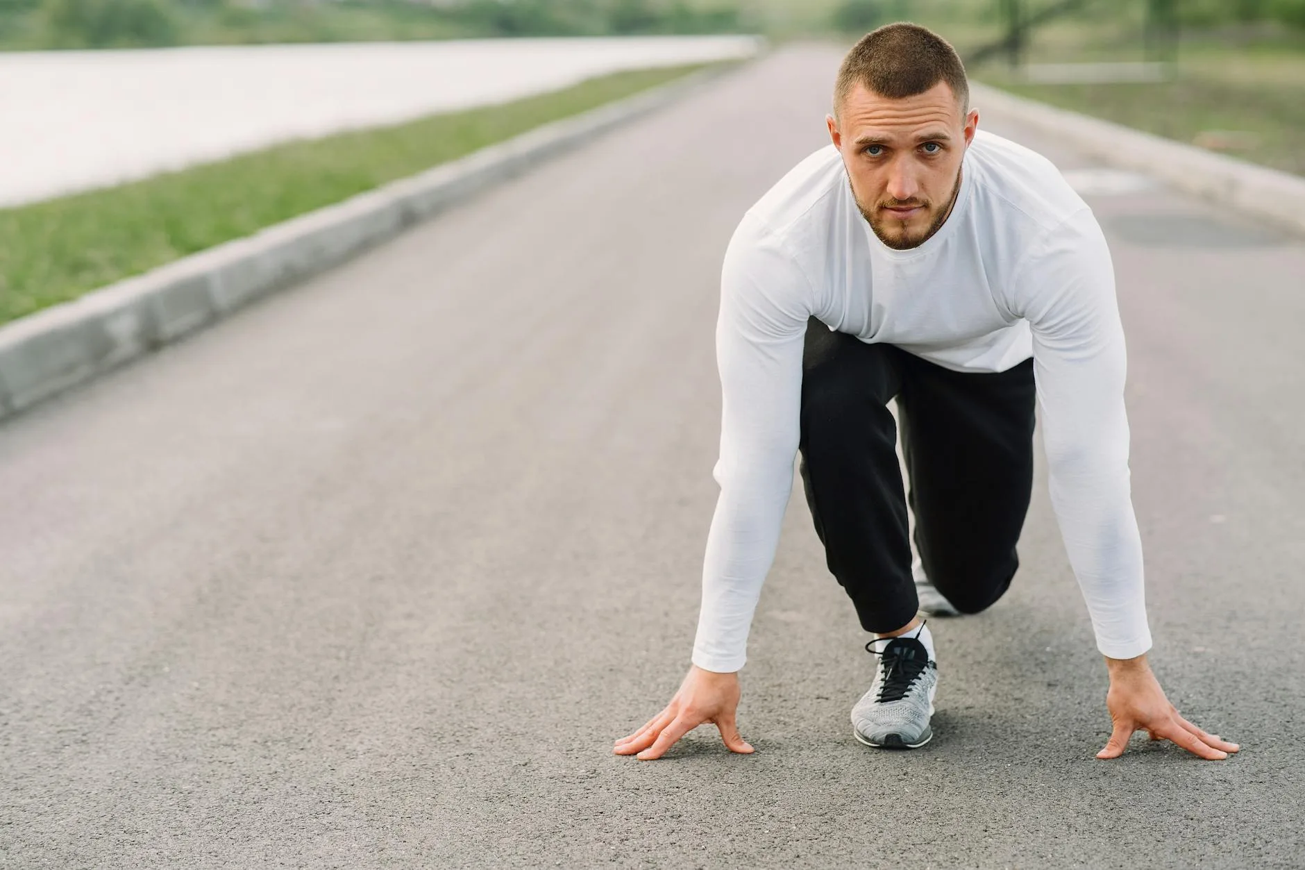 Runner in starting position on a path ready to run
