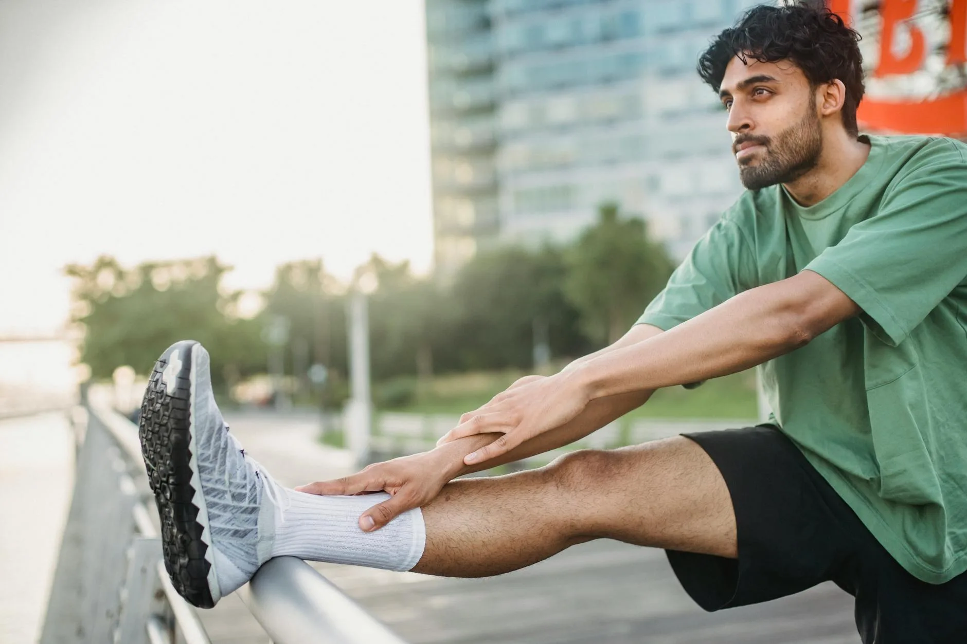 Runner stretching in a park after an interval session