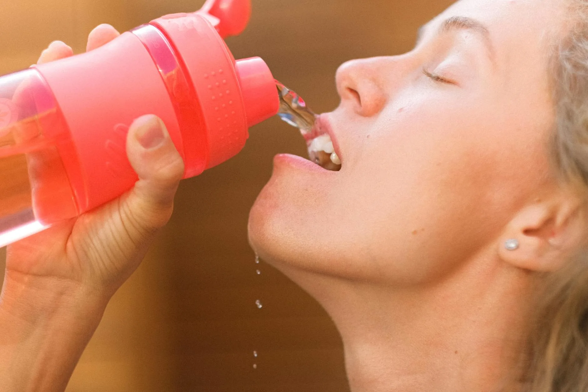 Runner drinking from water bottle during a long training run