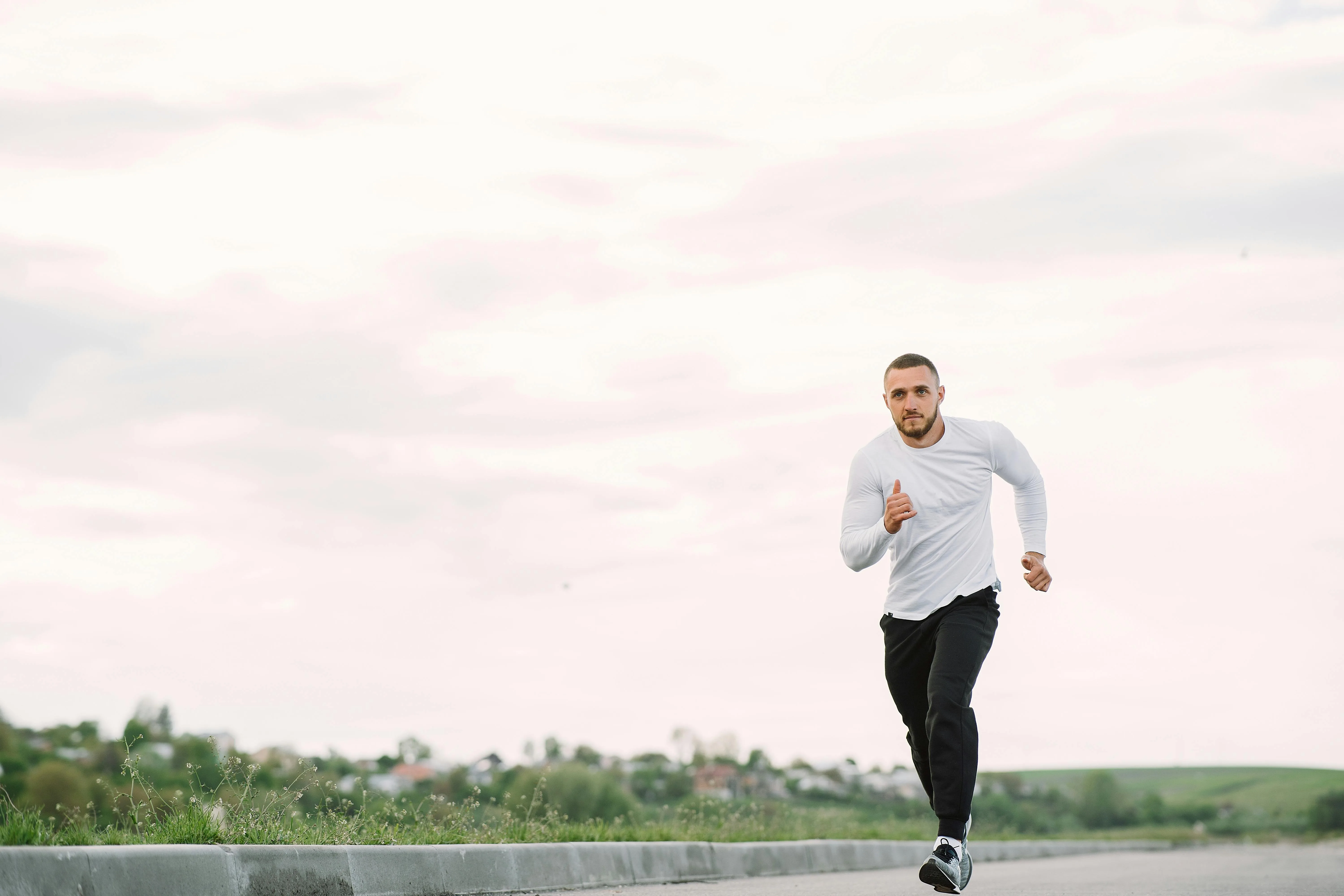 Runner training on an outdoor path wearing fitness gear