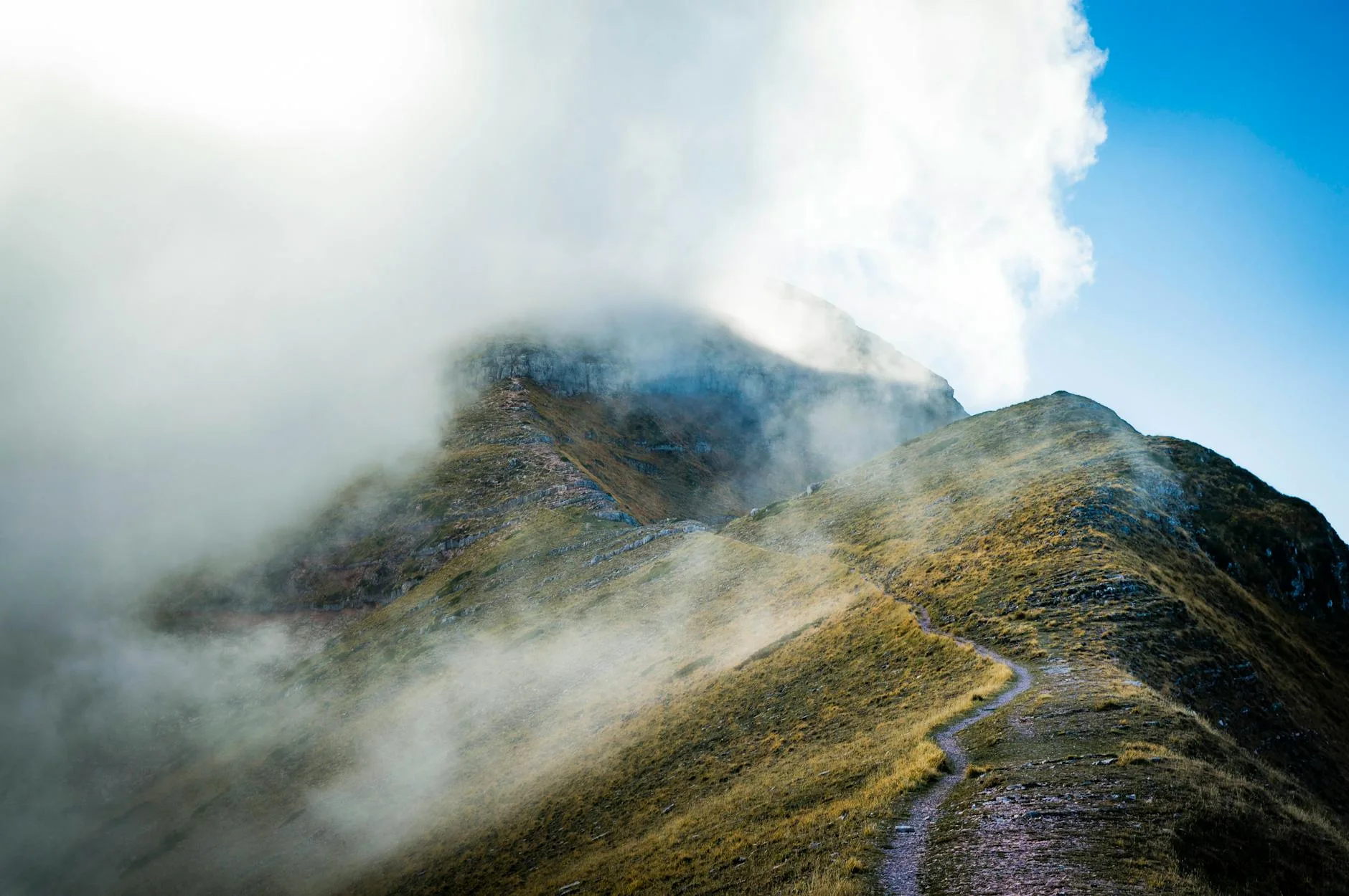 Trail runner in wet misty conditions on hilly terrain