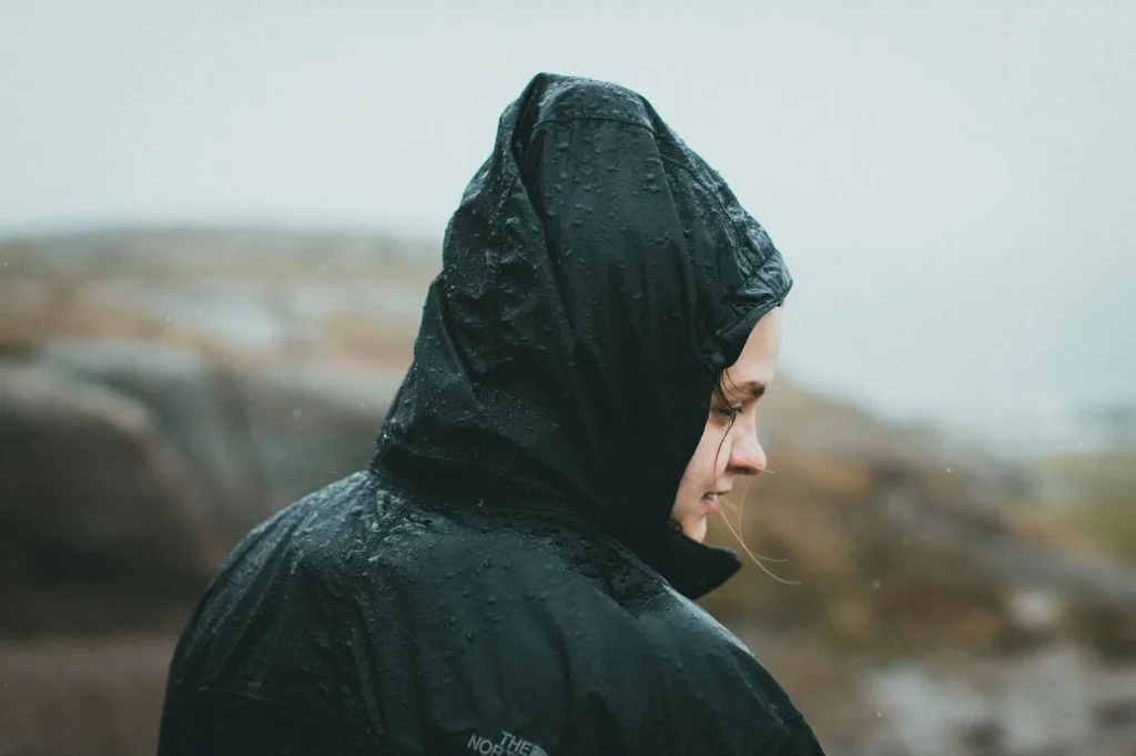 Runner wearing a waterproof jacket on a rainy road