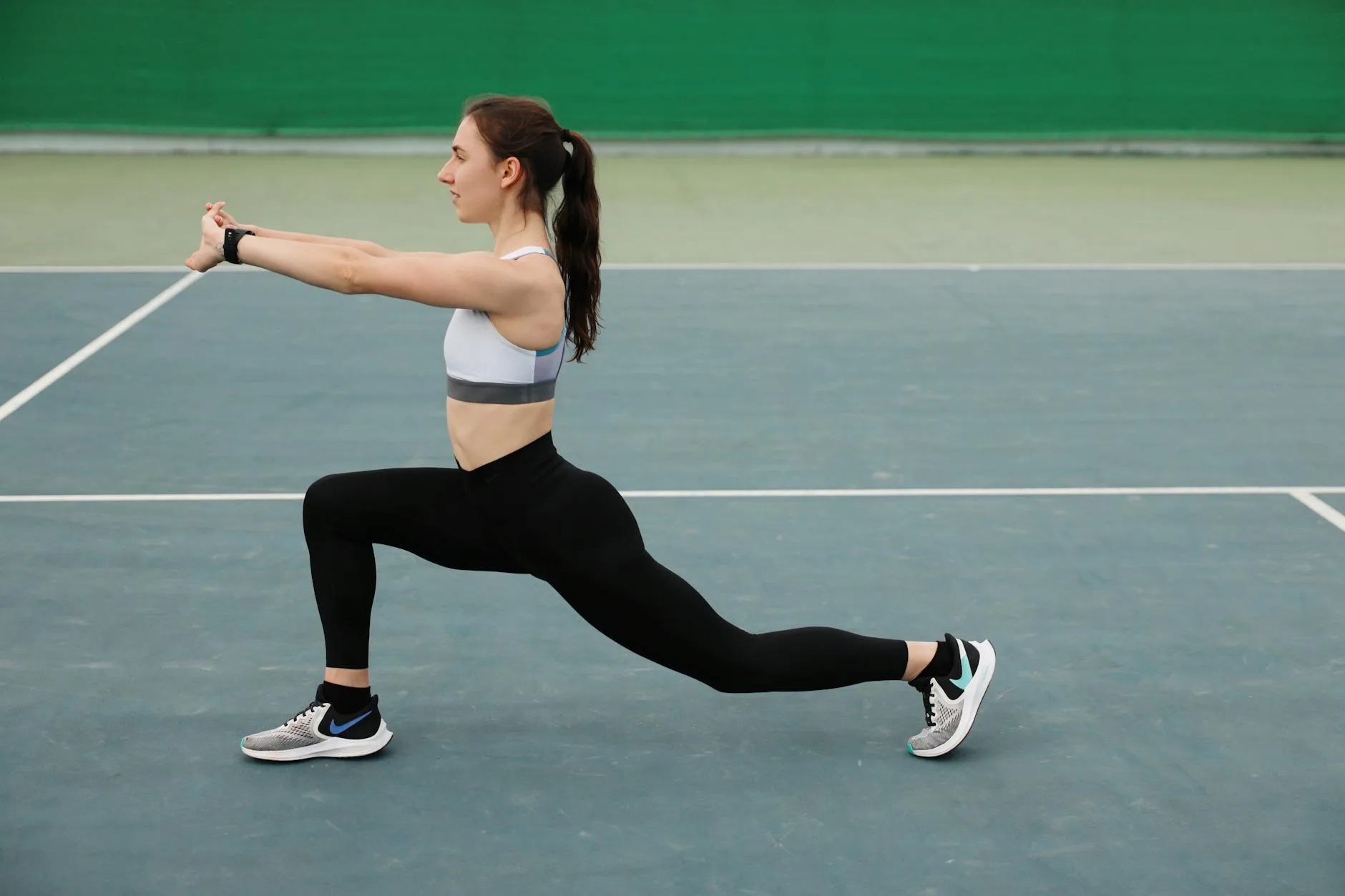 Person doing a walking lunge stretch before a run