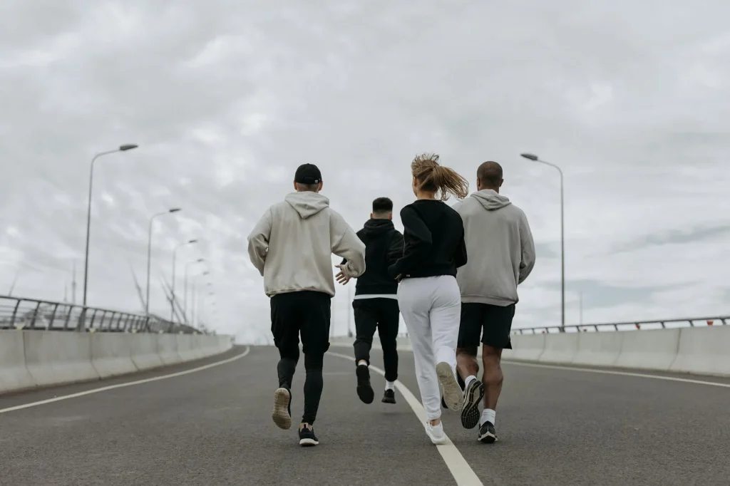 Group of runners jogging together through a park in the morning