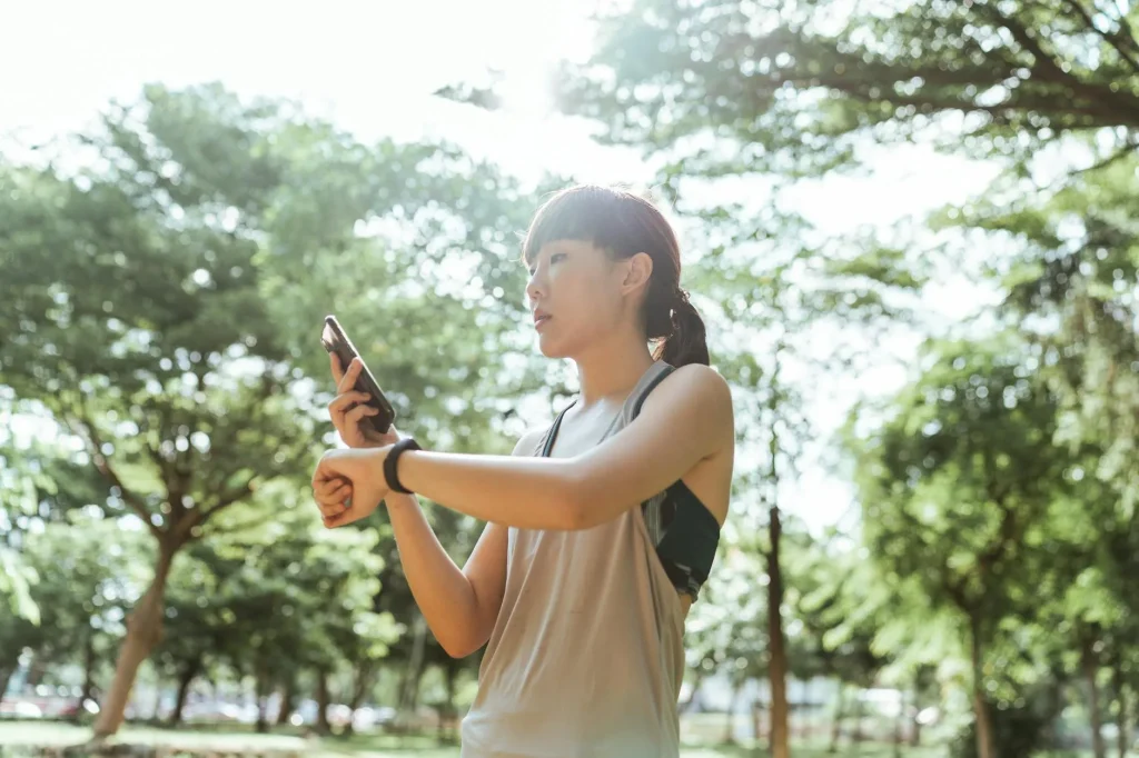Runner checking heart rate on a fitness watch during an outdoor run