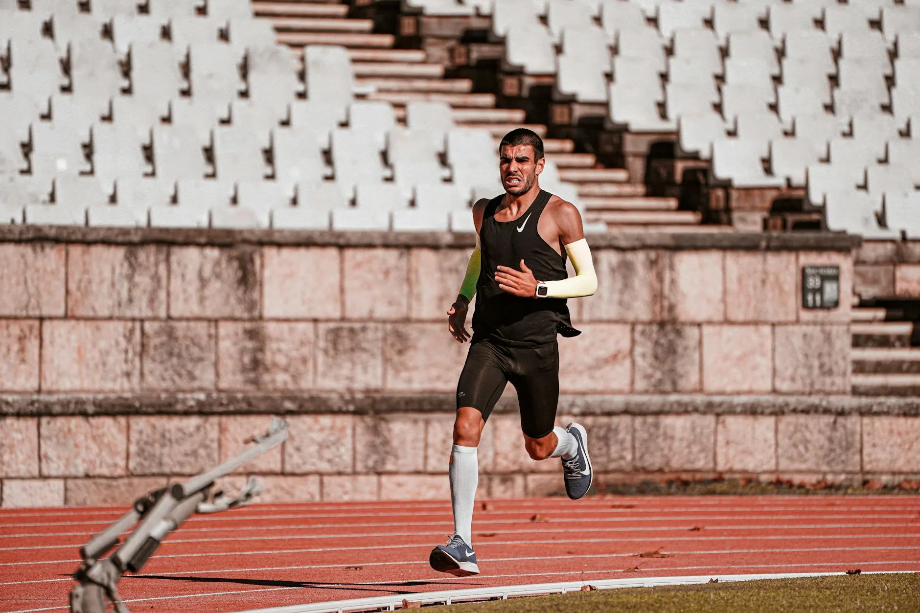 Runner sprinting at high intensity on an athletics track