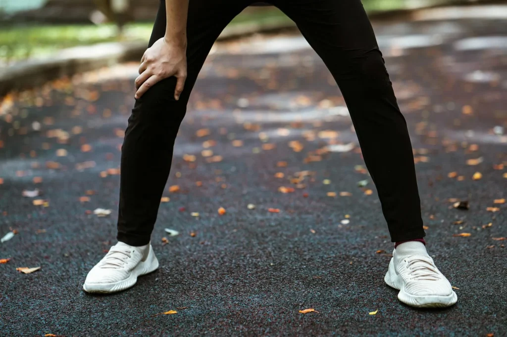 Runner stretching during a recovery session outdoors