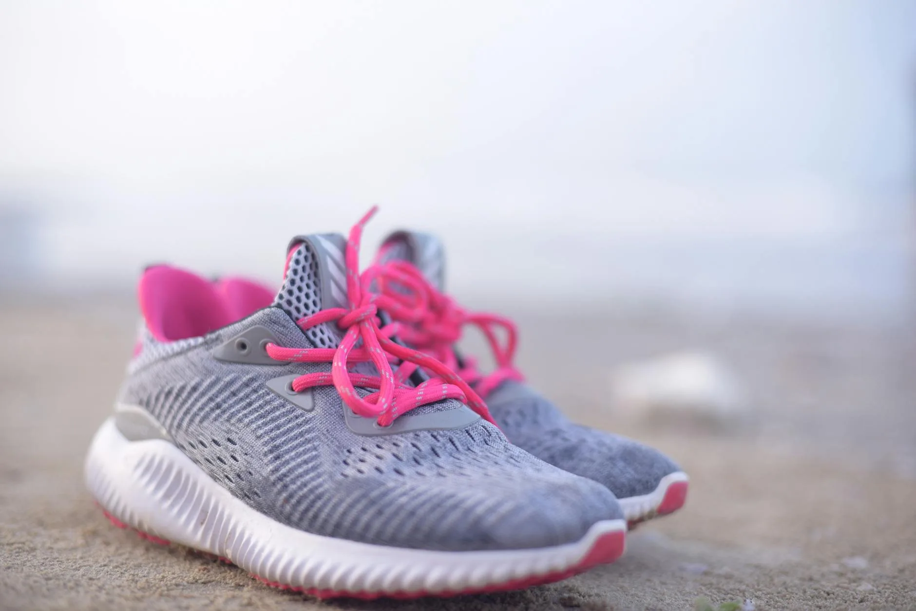 Pair of colourful running shoes on a wooden surface