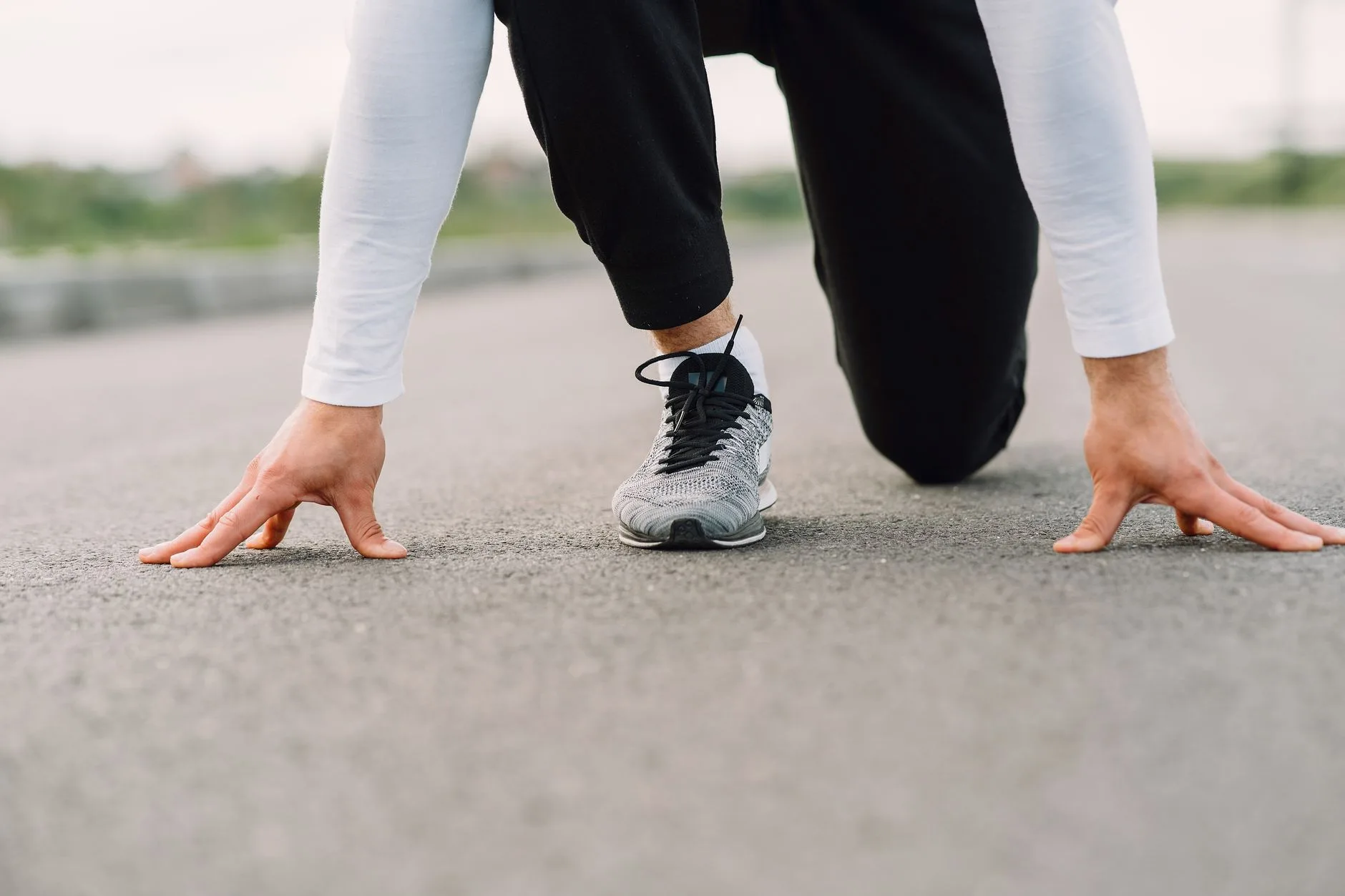 Cushioned running shoes landing on pavement during a run