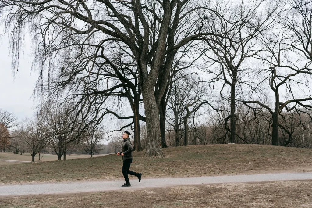 Runner training for a 10K on a park path