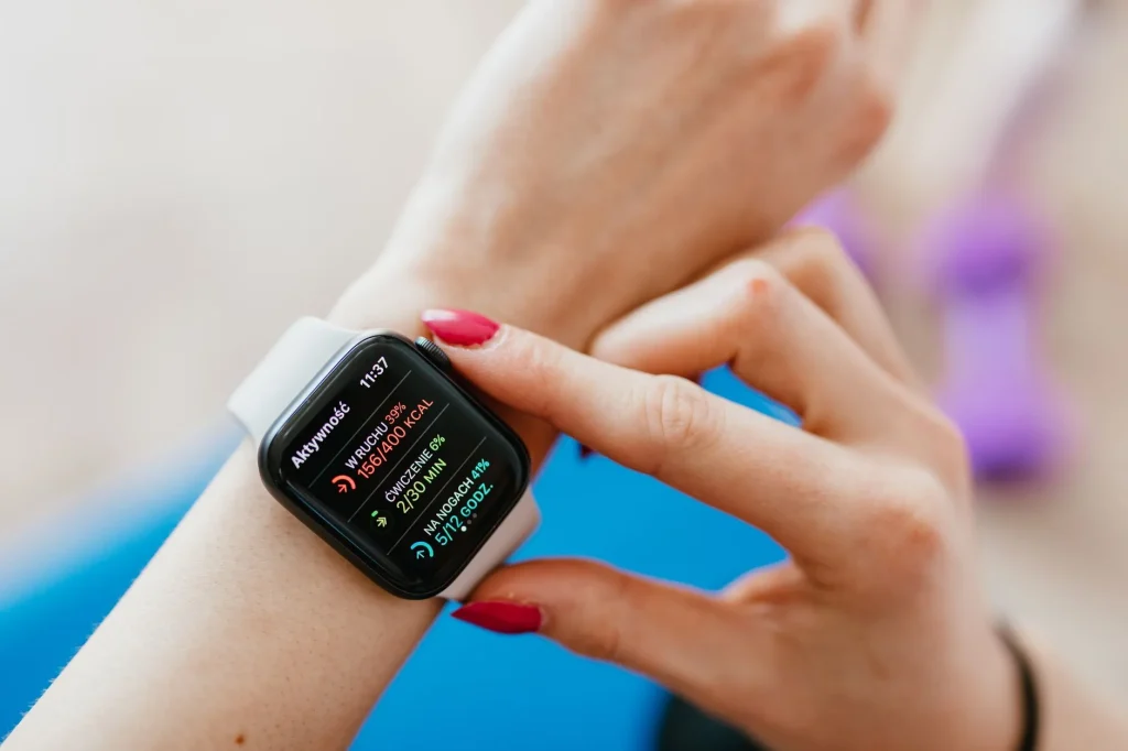 Runner checking heart rate data on a sports watch outdoors