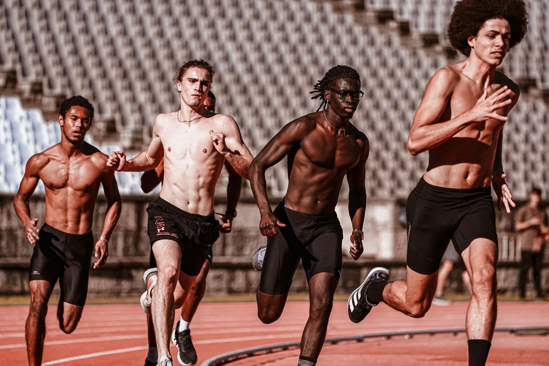 Runner on a track showing relaxed arm swing technique