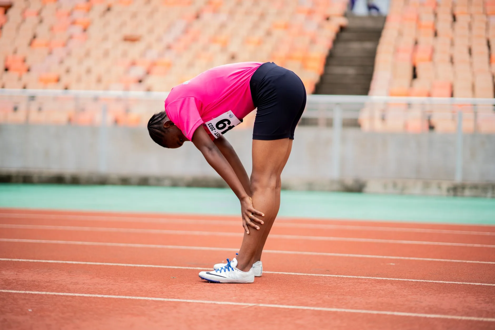 Runner warming up calves and hips before a run