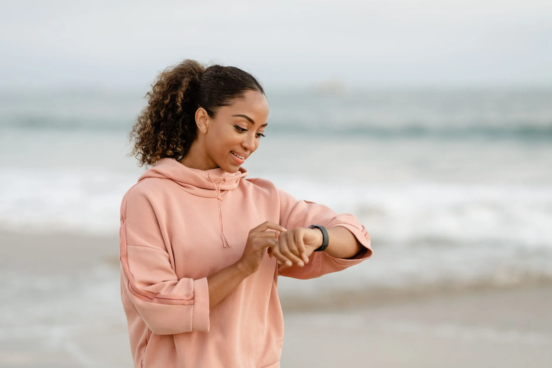 Runner checking a fitness watch before a cadence run