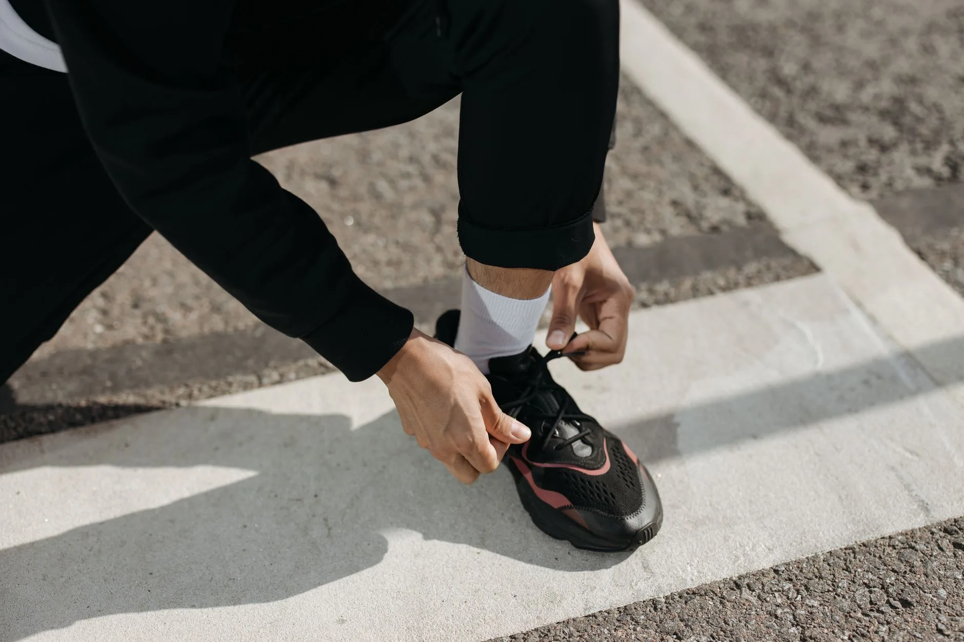Runner tying shoes before gait analysis and form practice