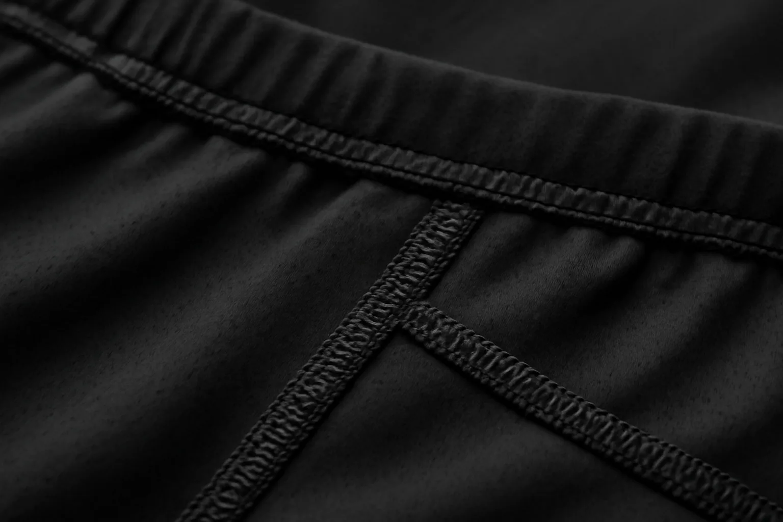 Close-up of flat seams on black running shorts
