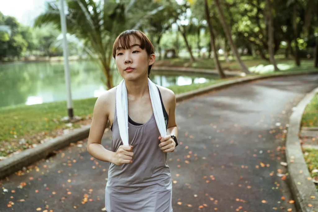 Runner checking a GPS watch after training in a park