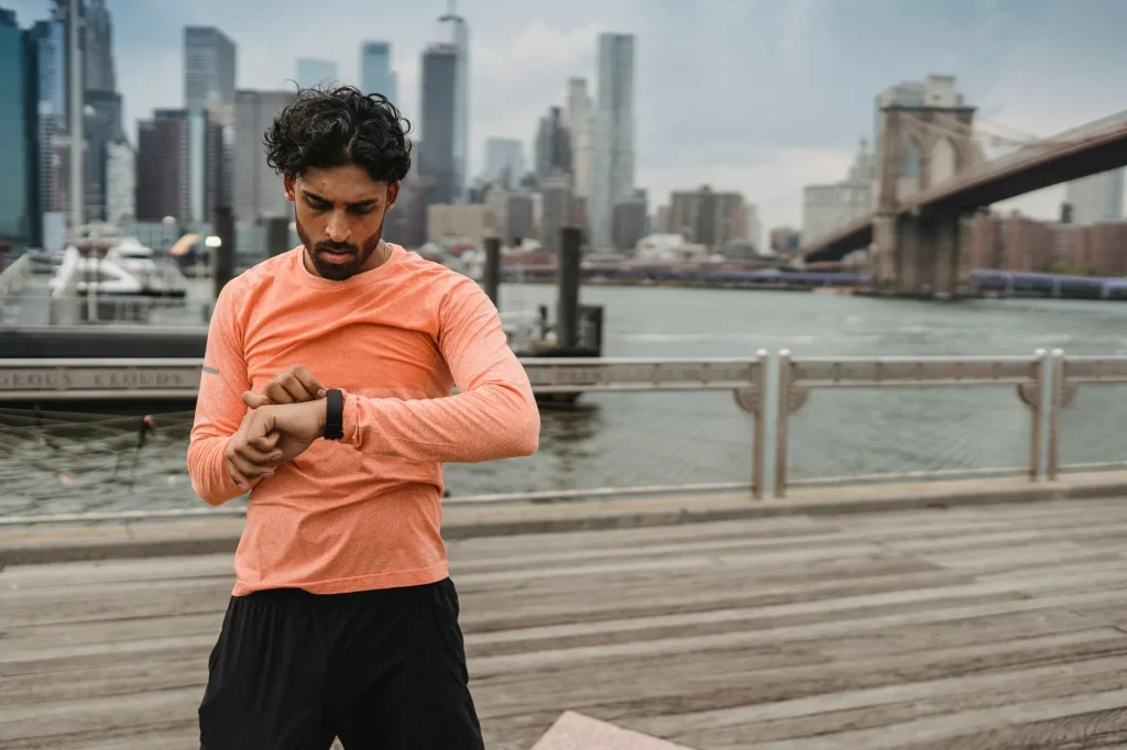 Runner checking a smartwatch during an outdoor run