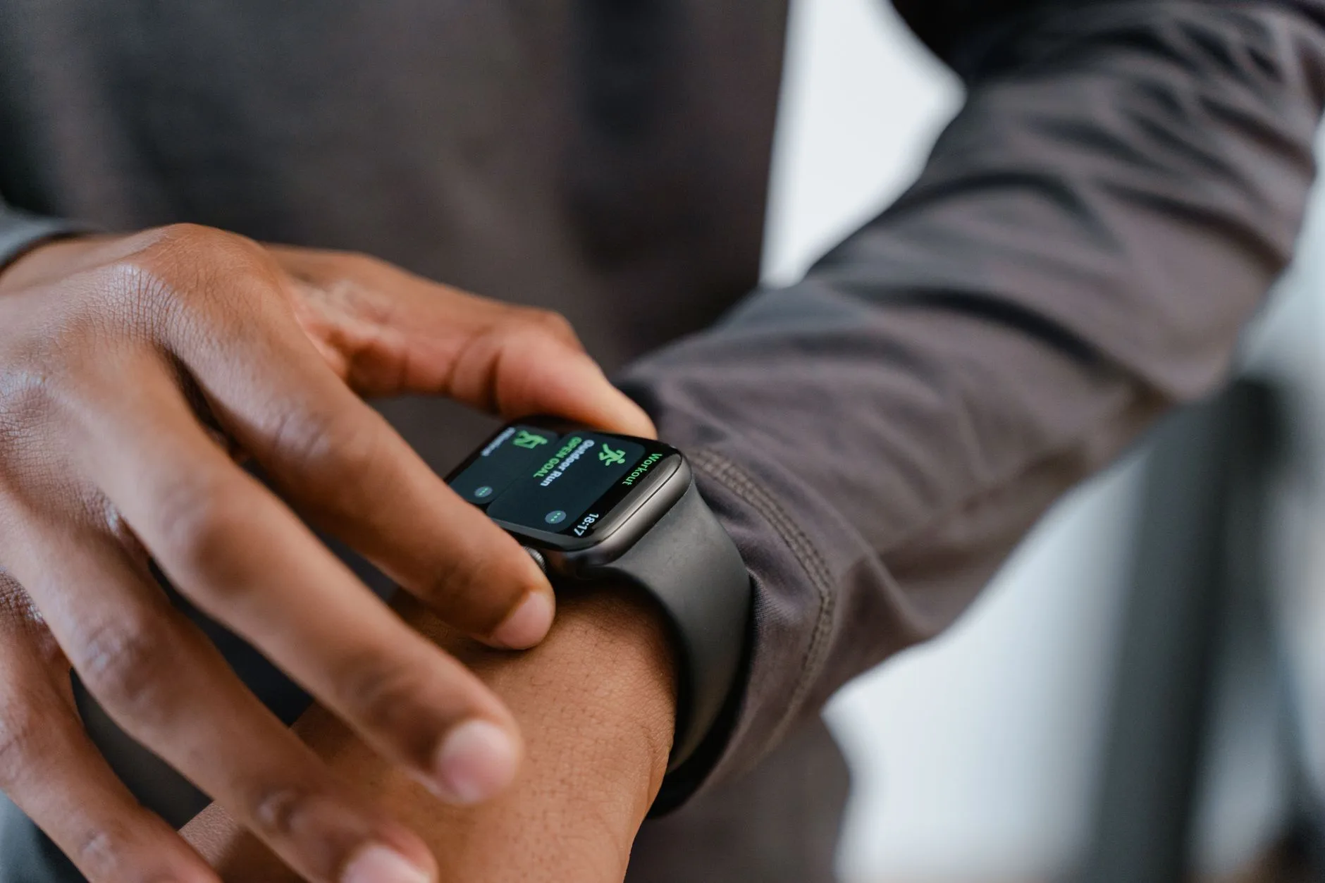 GPS running watch on a runner's wrist during a battery check