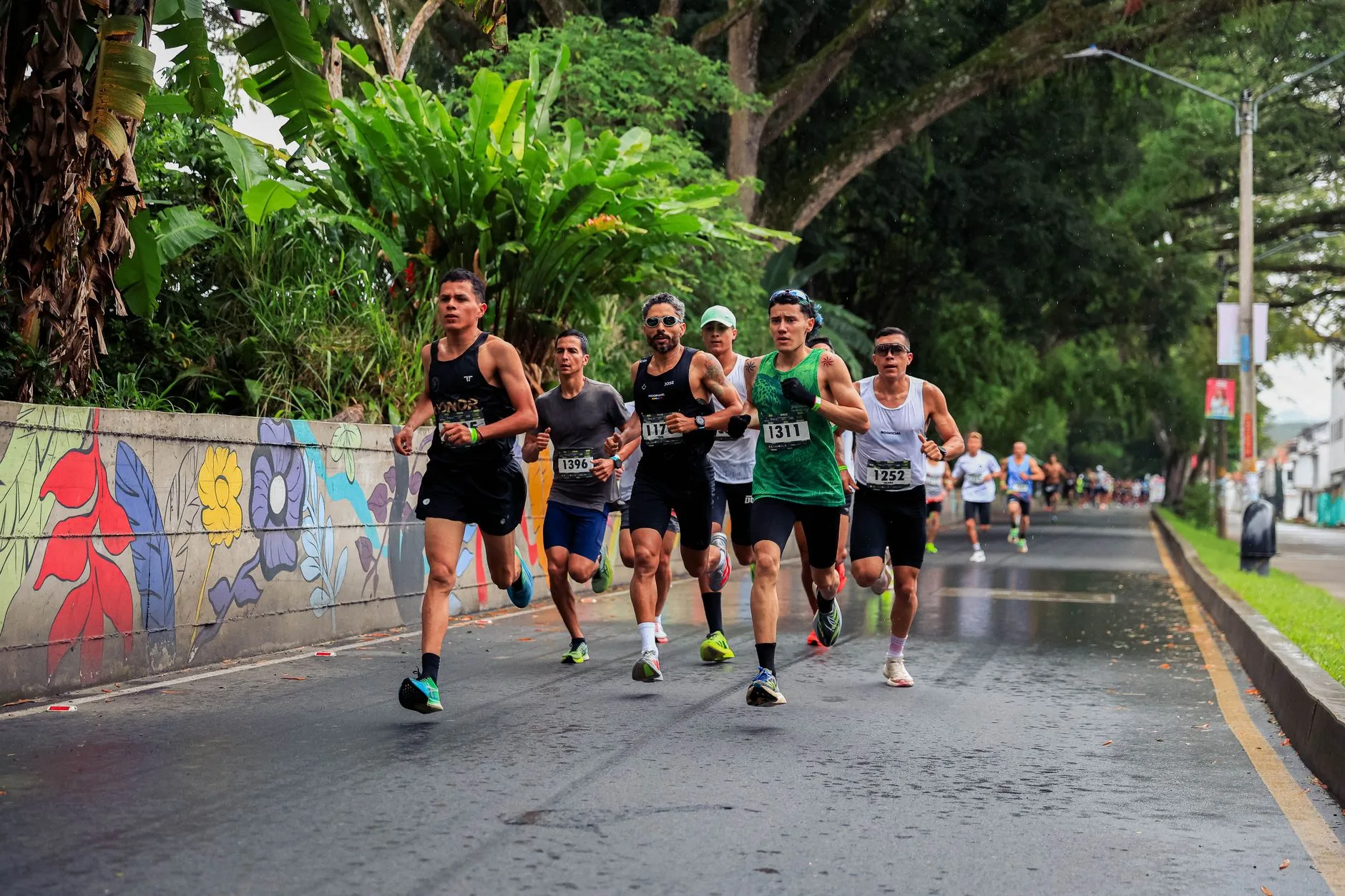 Road runners during a race on a wet city street